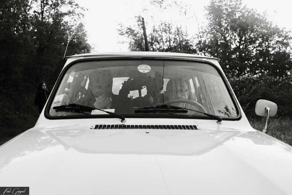 Car seen from the front on a tree-lined road