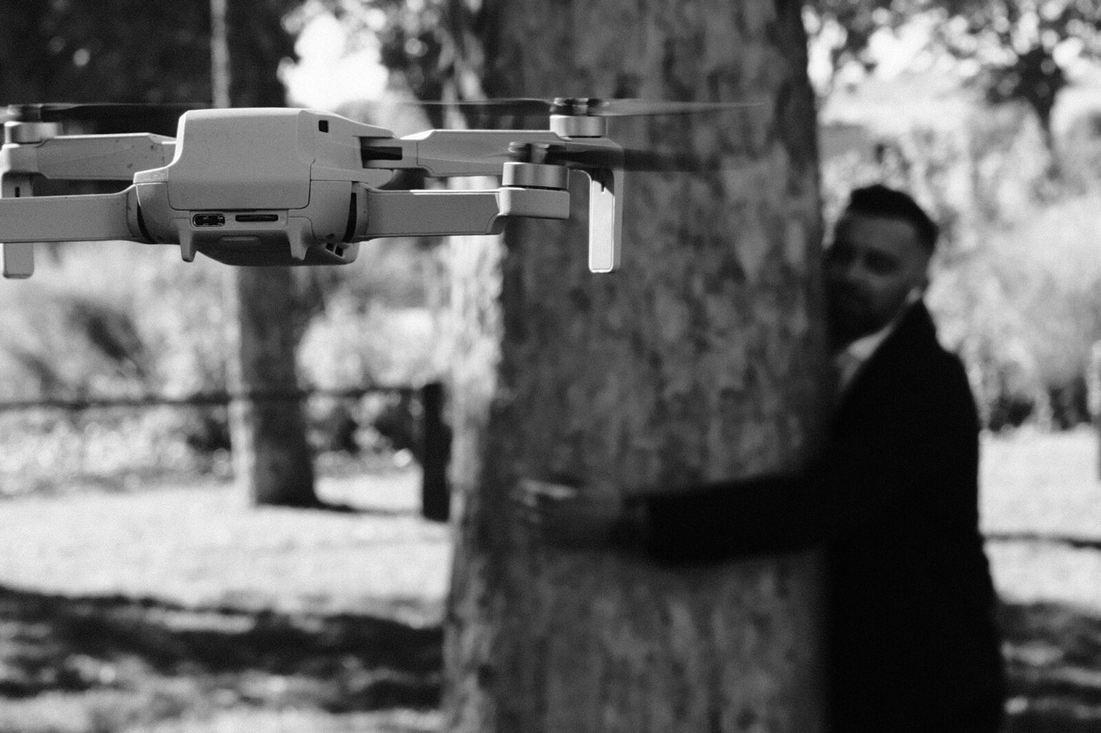 Drone shot in Vichy Drone in flight in front of a tree, person in the background