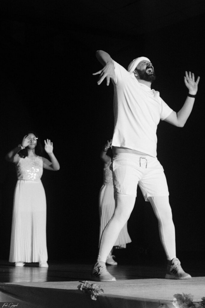 Two dancers on stage in mid-motion