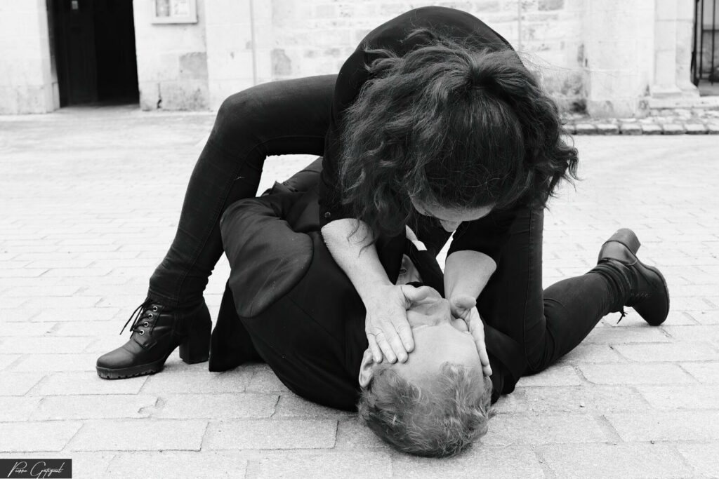 Two people on the ground in an artistic pose in black and white