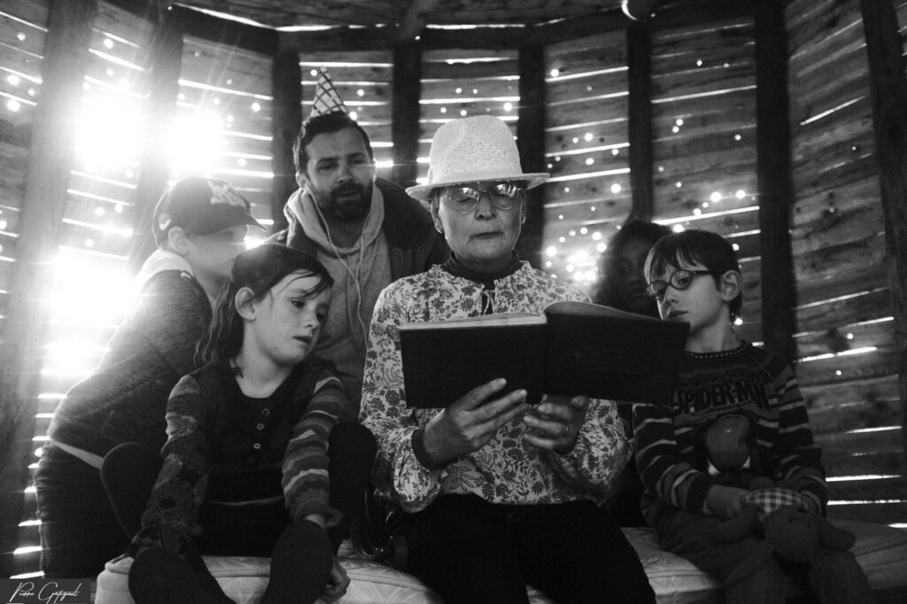 Adult reading a book to children sitting together