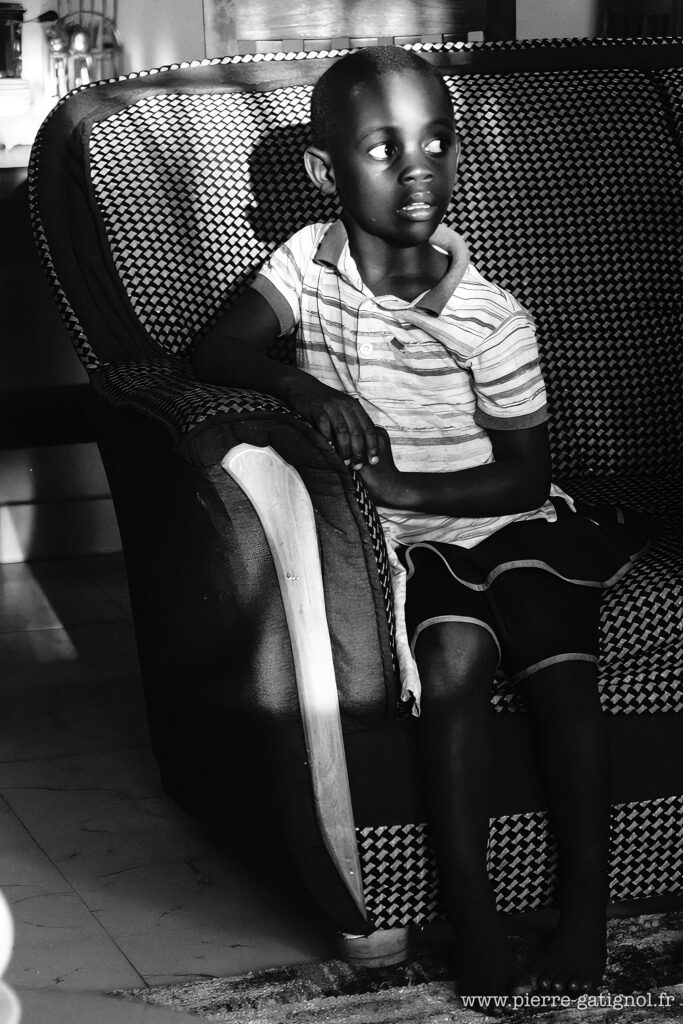 Young child sitting in an armchair, looking to the side