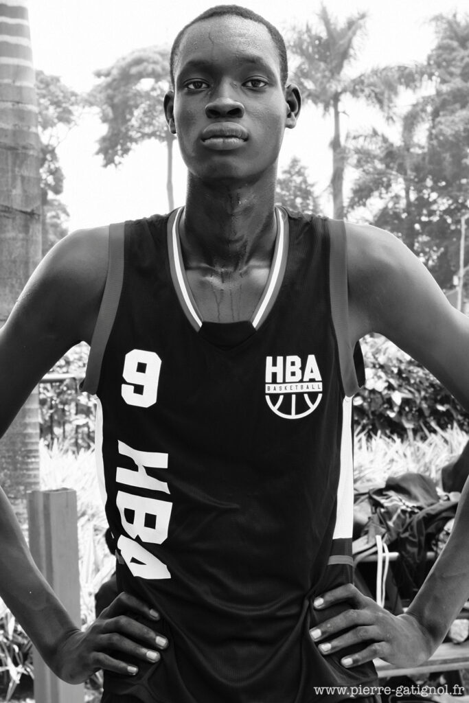 Young man in a sports tank top, hands on hips
