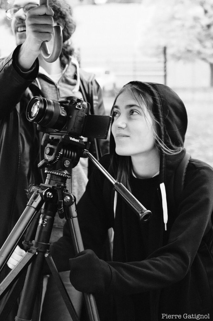 Two people around a camera on a tripod