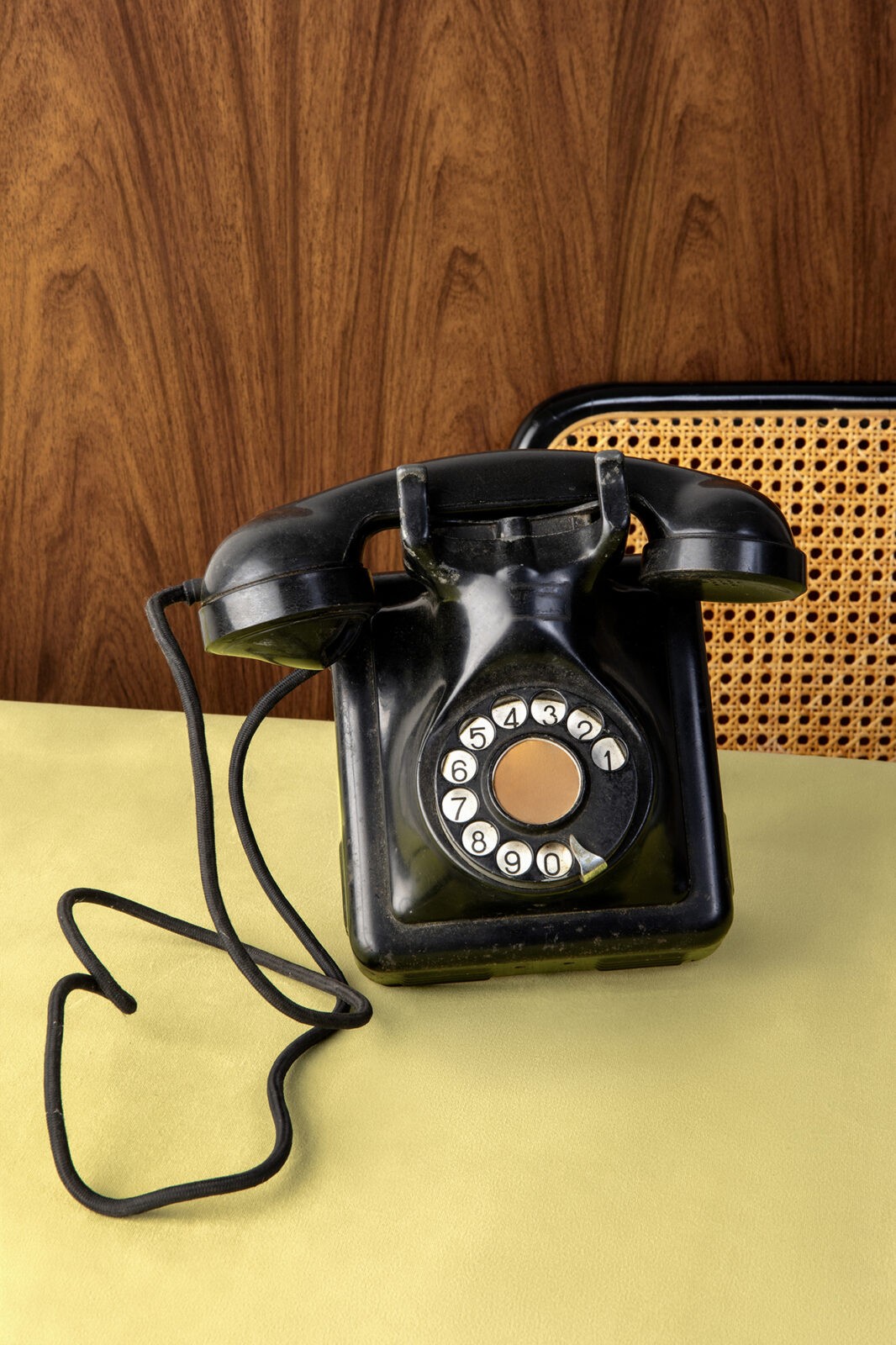 Vintage black telephone for a communications agency Black rotary phone on a light table